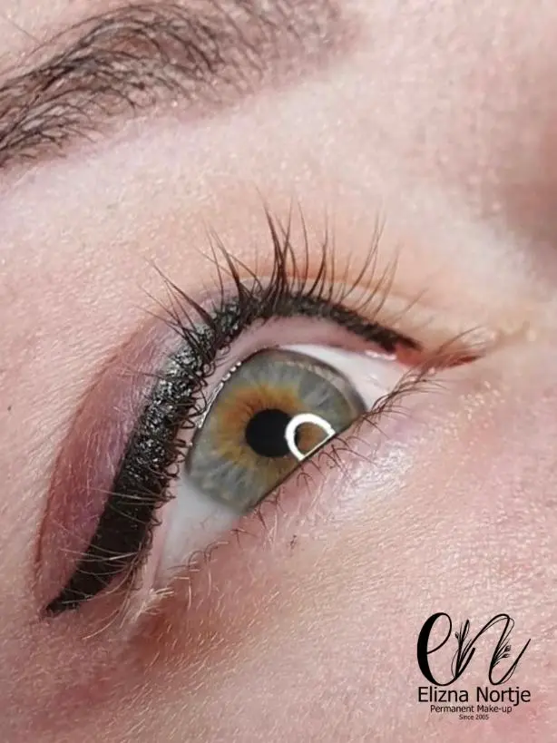Close-up of permanent eyeliner application on upper eyelid.